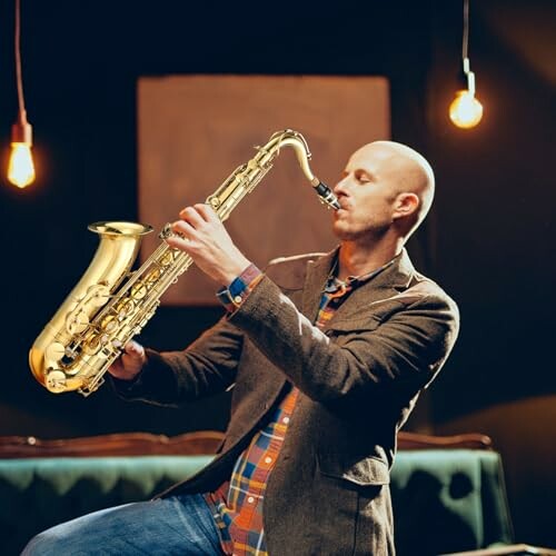 Man playing saxophone in a dimly lit room