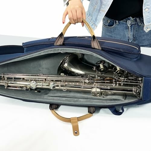 Person holding a bag with a saxophone inside