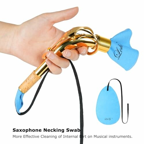 Hand holding saxophone neck swab for cleaning